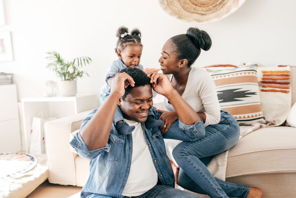 Young couple playing with toddler daughter