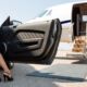 Woman's leg stepping out of car next to private jet