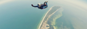 Man skydiving over island