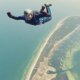 Man skydiving over island