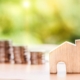 stack of coins with wooden house