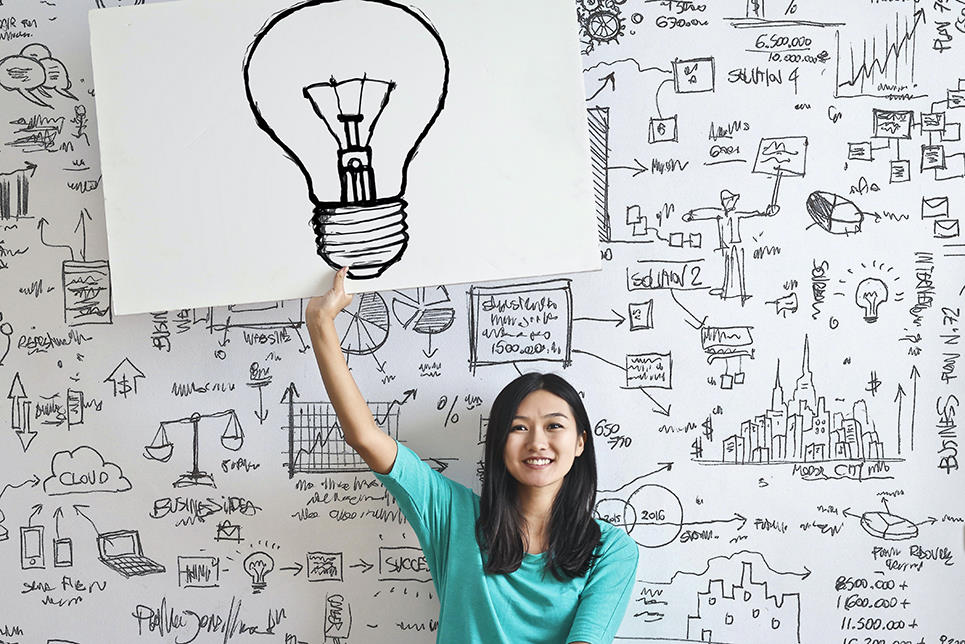 holding up a lightbulb drawing