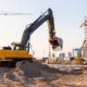 Excavator digging holes for development